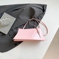 Pink patent leather shoulder bag with sleek trapezoid shape and silver buckle detail - Pink