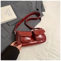 Detail of dark red high-gloss shoulder bag with double pockets on a grey suit - Red