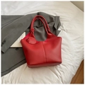 Detail of red tote bag featuring premium pebble grain texture and matching small pouch - Red