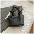 Close-up of black leather tote bag with lychee texture and round charm coin purse - Black