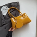 Glossy mustard yellow underarm handbag featuring a heart charm and minimalist design - Yellow