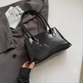 Minimalist black glossy tote bag with heart charm and metallic ring handles - Black