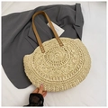 Detailed macro view of woven straw tote bag with brown leather handles and metal rivets - Beige Rainbow Stitching Style