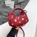 Red crescent shoulder bag in glossy patent leather with silver studs and bow accent - Red