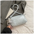 Detail view of light blue polka dot baguette bag with pearl chain and bow charm - Blue with Pendant