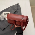 Close-up of deep burgundy vintage baguette bag with PARIS engraving and adjustable strap - Burgundy