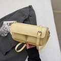 Detail of light yellow PU leather baguette bag with PARIS embossing and front pockets - Yellow