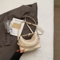 Detail of off-white lychee grain leather texture with silver buckles and wide strap - No Pendant / Off White