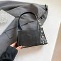 Retro black leather handbag with silver stud accents and unique trapezoid structure - Black