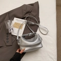 Macro detail of silver lychee texture leather on minimalist crossbody bag - No Pendant / Silver