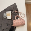 Pink cylinder crossbody bag with bear print and top handles in minimalist setting - No Pendant / Pink