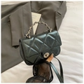 Close-up of black glitter quilted handbag with silver round twist lock and chain strap - Black