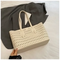 Detailed view of beige hollow-out tote bag featuring premium leather and punch-hole patterns - Off White