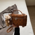 Detailed close-up of brown PU leather bag featuring cartoon bear print and plush charm - Brown with Pendant