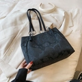 Black tote bag with 3D heart textures and silver metal rings on a beige blazer - Black without Pendant