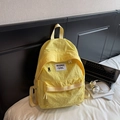 Minimalist yellow nylon backpack with square logo patch in a modern aesthetic setting - No Pendant / Yellow
