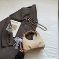 Detail view of beige herringbone texture bag with elegant lace bow and pearl charm - Khaki With Pendant