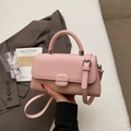 Detalle de bolso rosa de cuero trenzado con asa superior y bandolera - Rosa