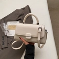 Detailed view of cream crossbody bag featuring woven texture and silver metal clasp detail - Off White