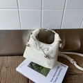 Chic cream-white pleated dumpling handbag with bow accent and silver crackle texture - Off White