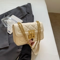 Détail de sac à main matelassé crème avec fermoir géométrique doré et bandoulière chaîne - Blanc Cassé