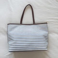 Minimalist canvas tote bag with blue stripes and brown leather straps for daily commute - Blue