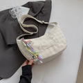 Detail of checkered dumpling bag featuring bear heart embroidery and colorful pom-pom tassel - Off-White (With Rainbow Pendant)