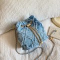 Blue denim bucket bag with frayed quilted patterns and gold pearl chain strap - Blue