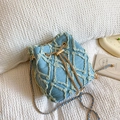 Light blue denim bucket bag featuring frayed geometric patterns and a gold chain strap - Light Blue