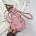 Detail of pink mini round bag with pebble leather texture and metal bottom studs - Pink