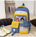 Detail view of Japanese style backpack with clear pocket, pins and cute cartoon accessories - Blue