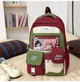 Macro detail of wine red school backpack featuring transparent window and mini pouch - Red