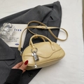 Retro cream beige bowling handbag with silver lock and adjustable crossbody strap - Yellow with Pendant