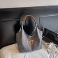 Grijze canvas shopper met oranje TCT-borduursel en contrasterende bruine leren handvatten - Donkerbruin