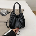 Minimalist black pleated bucket bag with gold lettering and adjustable crossbody strap - Black