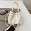 Cream white bucket bag with cloud pleats and adjustable strap for shoulder or crossbody use - White