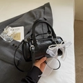 Detail of black cylindrical pillow bag with white pearl charm and lace bow decoration - With Pendant / Black