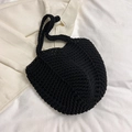 Detailed view of black hand-knitted tote bag with intricate crochet texture and round handles - Black