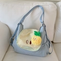Detail view of light blue nylon backpack with cute cartoon face and pineapple plush charm - Blue Pear (With Pendant)
