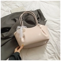 Detail of light pink patent leather tote with lace pearl bow charm and side pleats - With Pendant / Pink