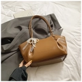 Detail of caramel patent leather tote with delicate white lace bow and pearl chain - With Pendant / Brown
