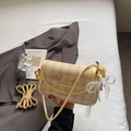 Detail of yellow checkered bag with heart print, pearl bow charm and adjustable strap - Yellow with Pendant