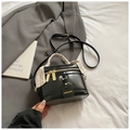 Black bucket crossbody bag with gold hardware and floral scarf detail on the handle - Black