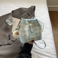 Fashionable light blue checkered canvas bucket bag with plush charm and gold hardware - Blue with Charm