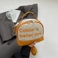 Detail van een geel-beige halfronde canvas crossbodytas met handvat en schouderriem - Geel