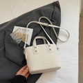 Minimalist beige bucket bag with textured vertical stripes and adjustable silver strap - Off-white Without Pendant