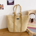Detail der beigen geflochtenen Tragetasche mit Netzdesign und dekorativem Knotengriff - Beige & Khaki