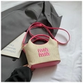 Detailed top view of a mini straw basket bag with pink leather trim and logo embroidery - Pink Without Pendant