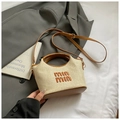 Detail of woven straw handbag featuring brown leather handles and embroidered logo - Brown No Pendant