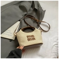 Detail of woven straw basket bag with leather base and brown embroidery on fabric - Coffee without Pendant